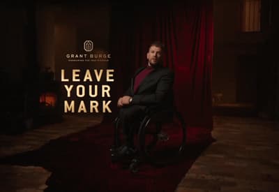 a man in a suit sitting in a wheel chair