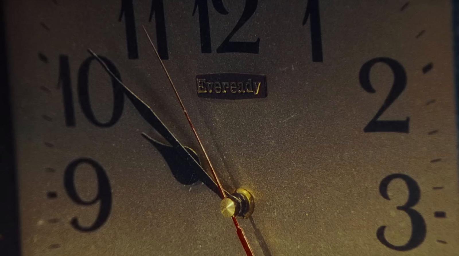 a close up of a clock face with a red second hand