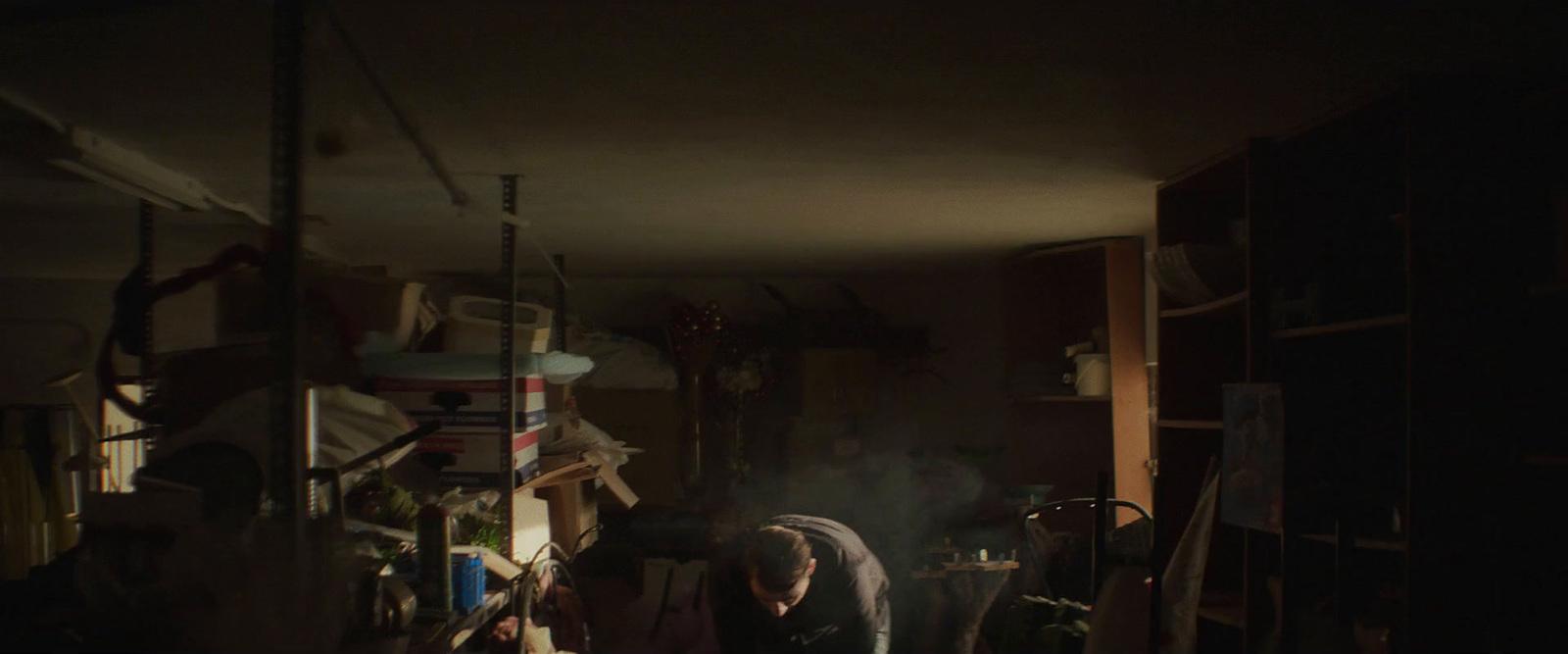 a man standing in a kitchen next to a stove top oven