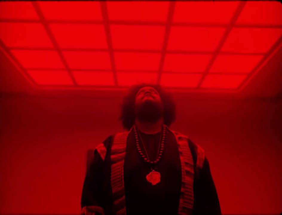 a man standing in front of a red light