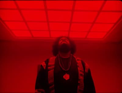 a man standing in front of a red light