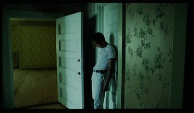 a man standing in front of a door in a room