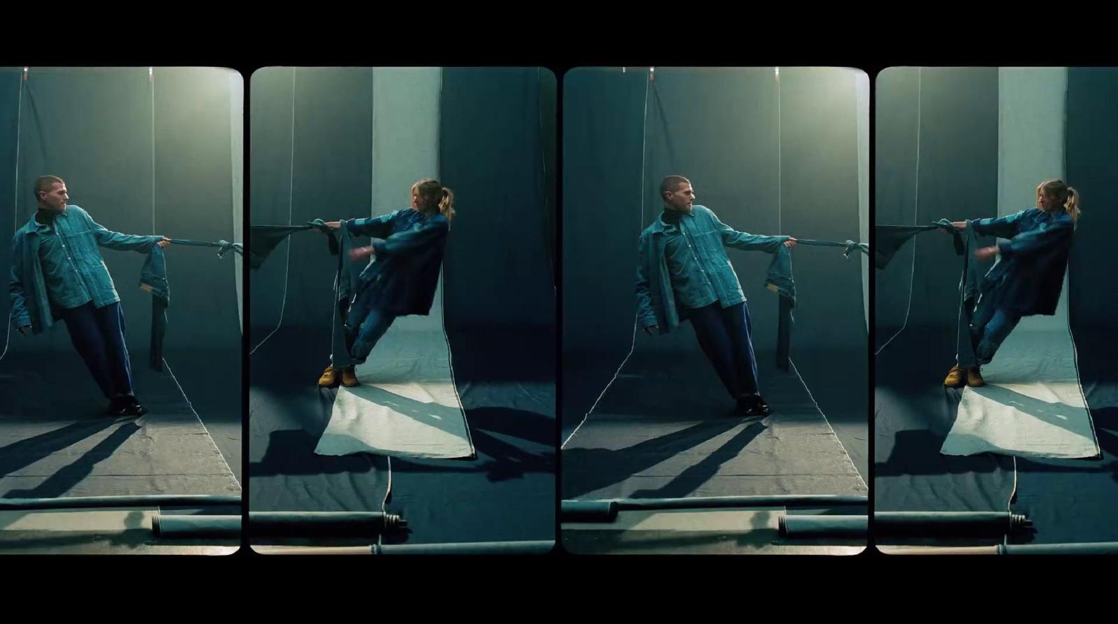 a woman in a blue shirt is holding a rope