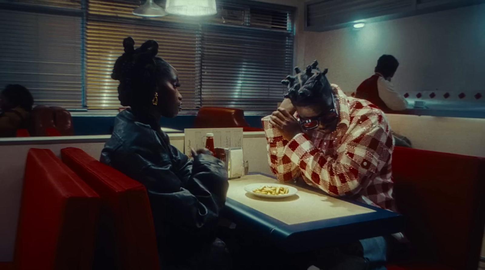 two people sitting at a table in a restaurant