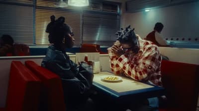 two people sitting at a table in a restaurant