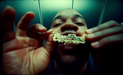 a man is holding his teeth in front of his face
