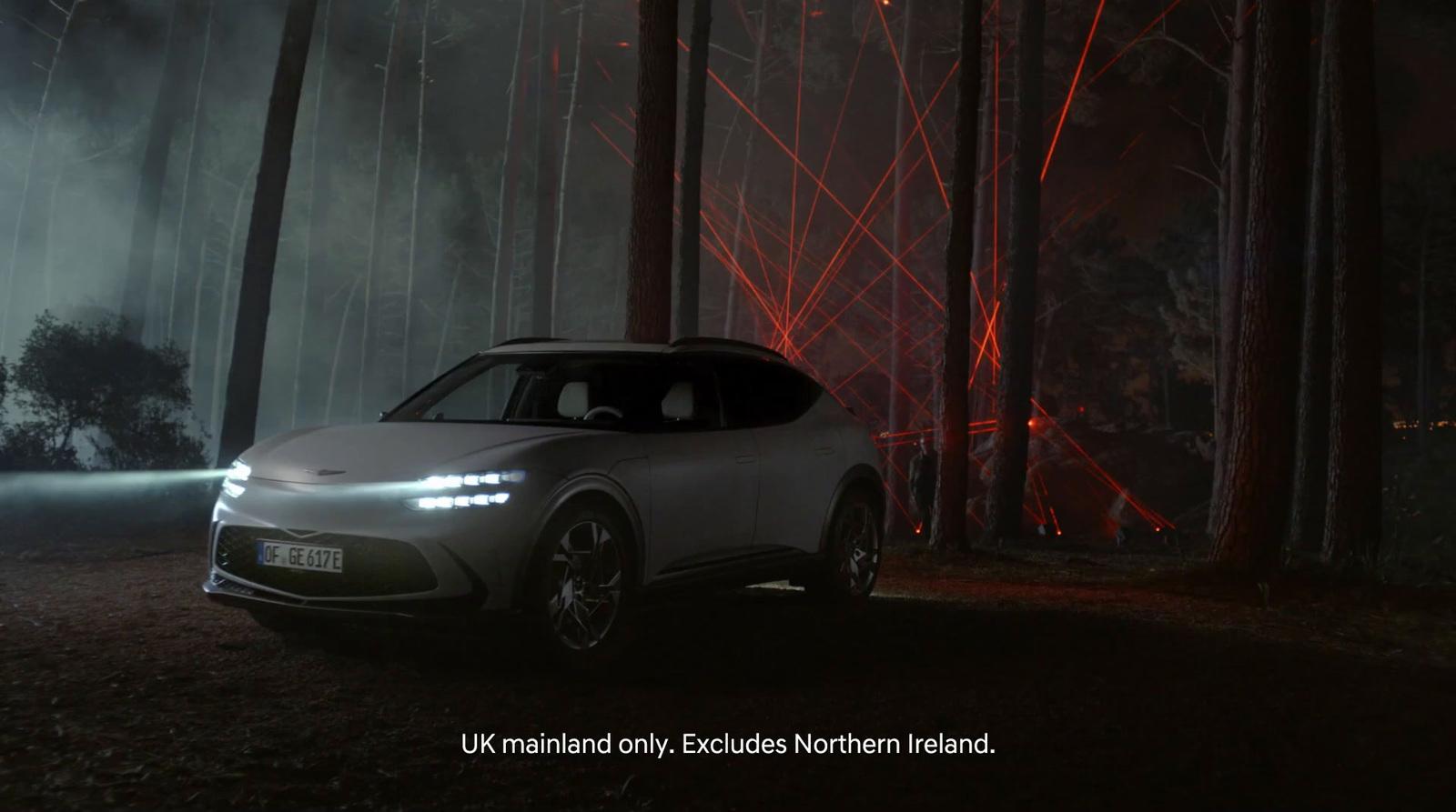 a car parked in a forest at night