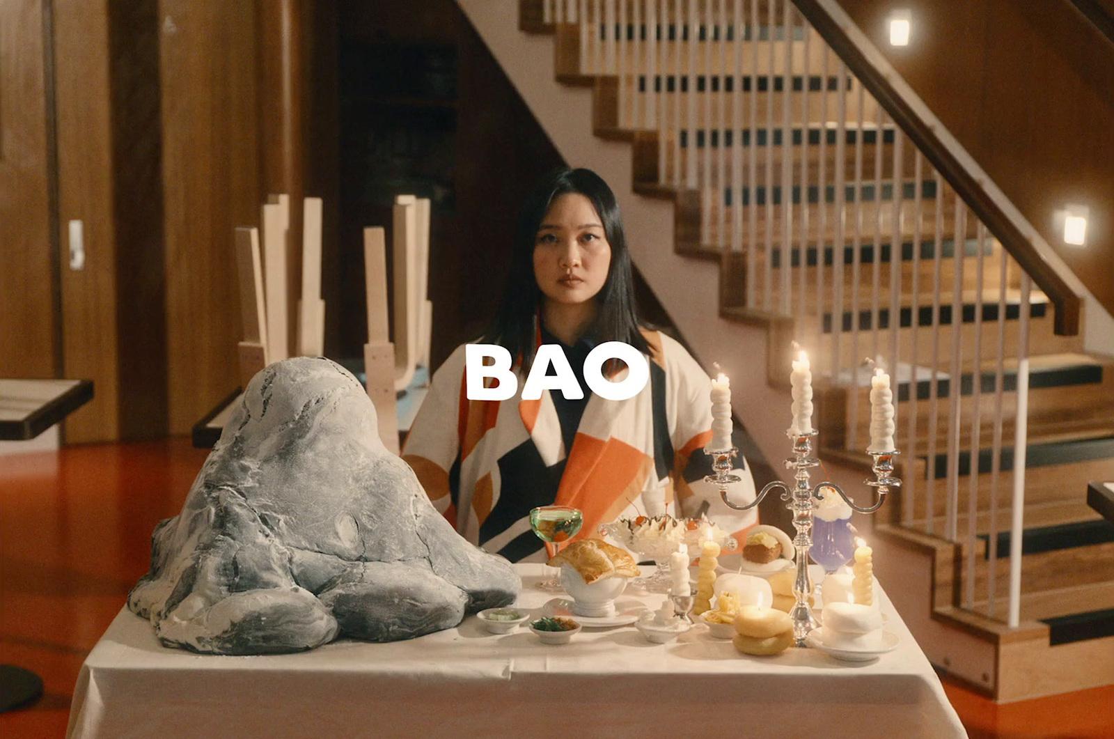a woman sitting at a table with a plate of food