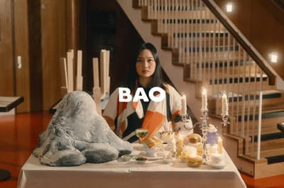 a woman sitting at a table with a plate of food
