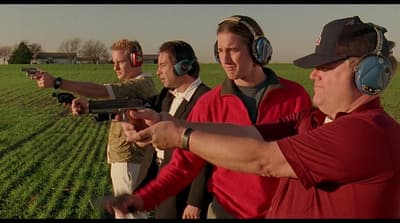 a group of men standing next to each other holding guns