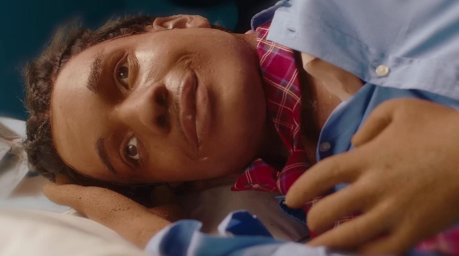 a man laying on a bed with his head on the pillow