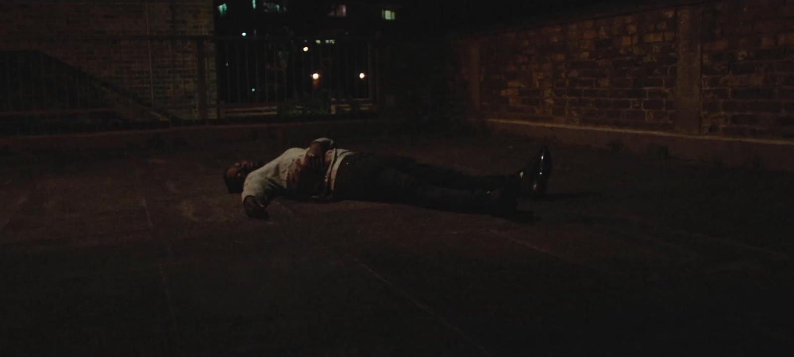 a person laying on the ground in the dark