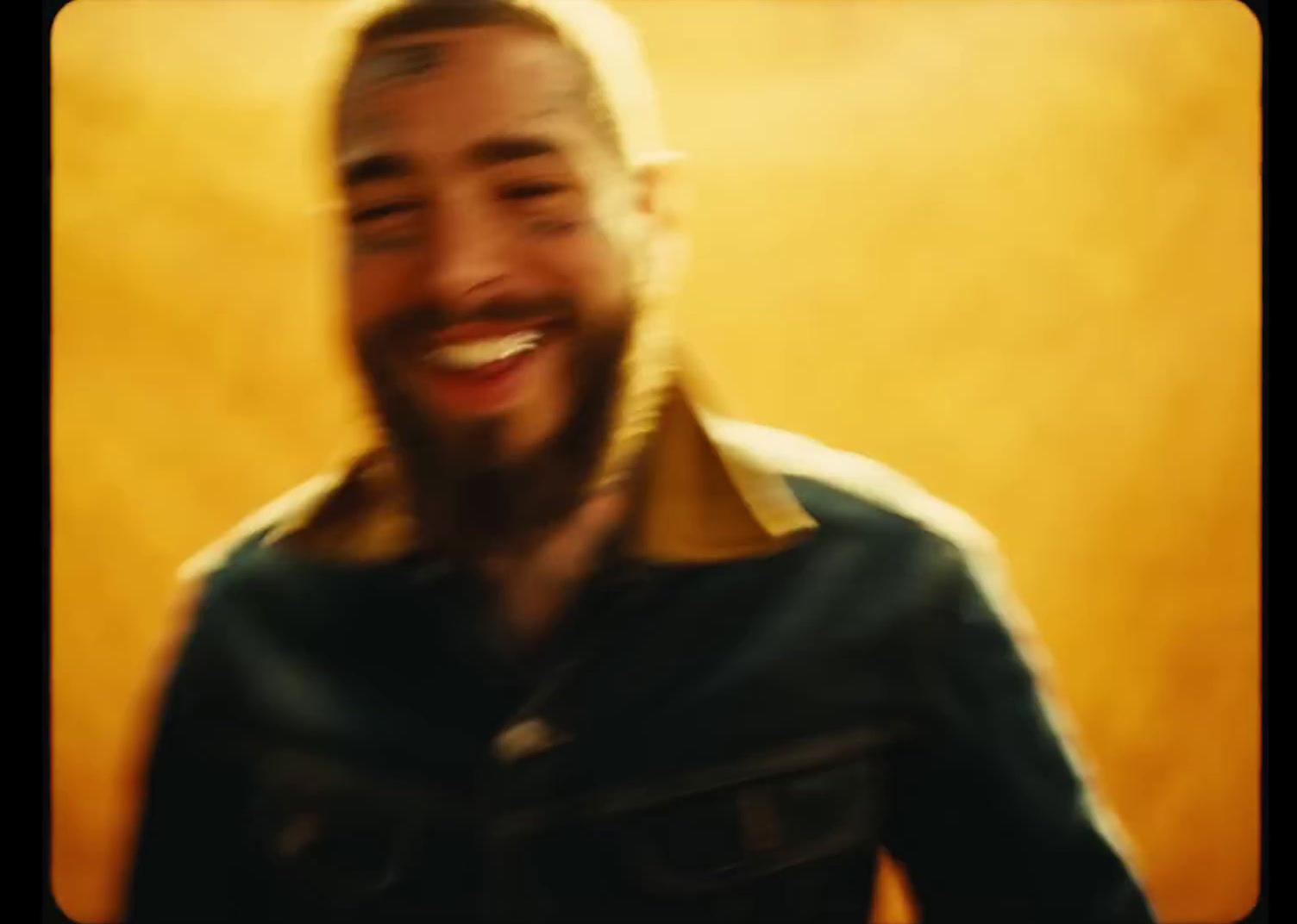 a man with a beard and a goatee smiles at the camera