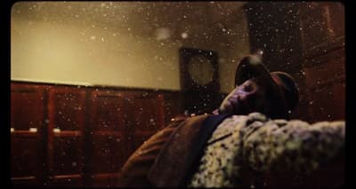 a person laying on a bed covered in snow