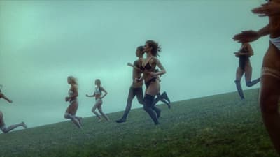 a group of women running across a lush green field