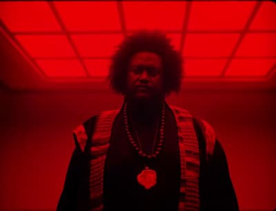 a man standing in a room with a red light