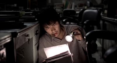 a man sitting in front of a computer desk