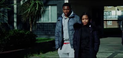 a man and a woman walking down a sidewalk