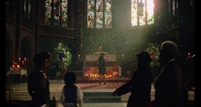 a group of people standing in front of a church