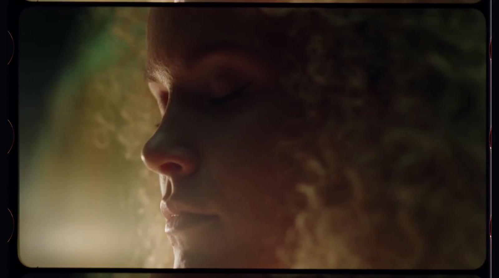 a close up of a woman's face with her eyes closed