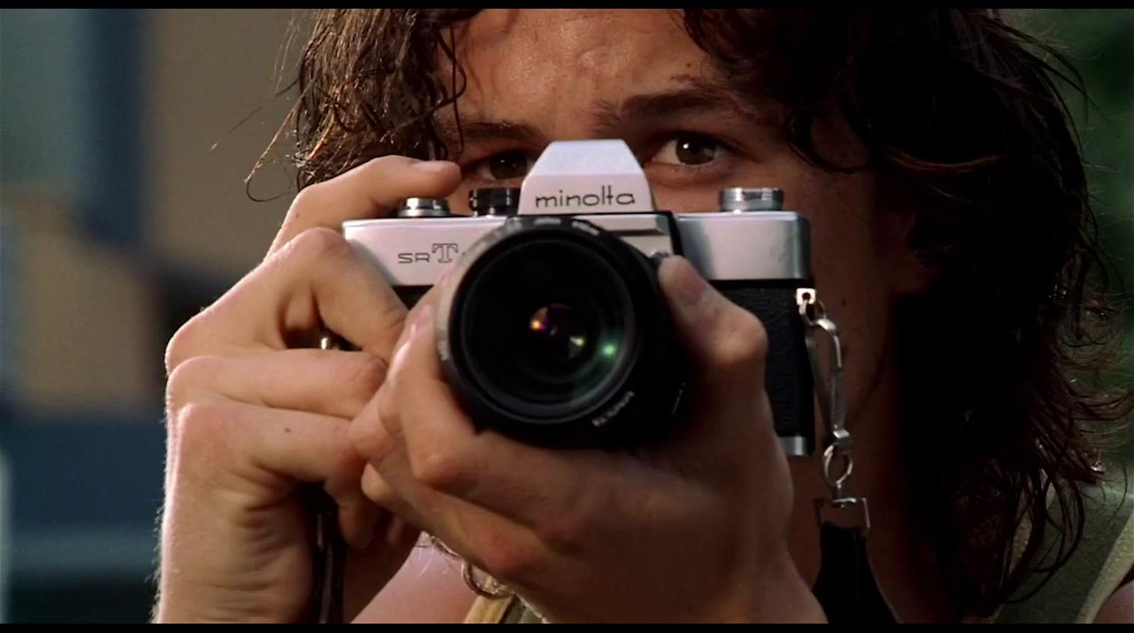 a man holding a camera up to his face