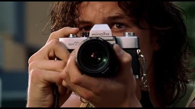 a man holding a camera up to his face