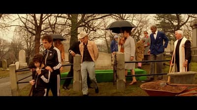 a group of people standing around a cemetery