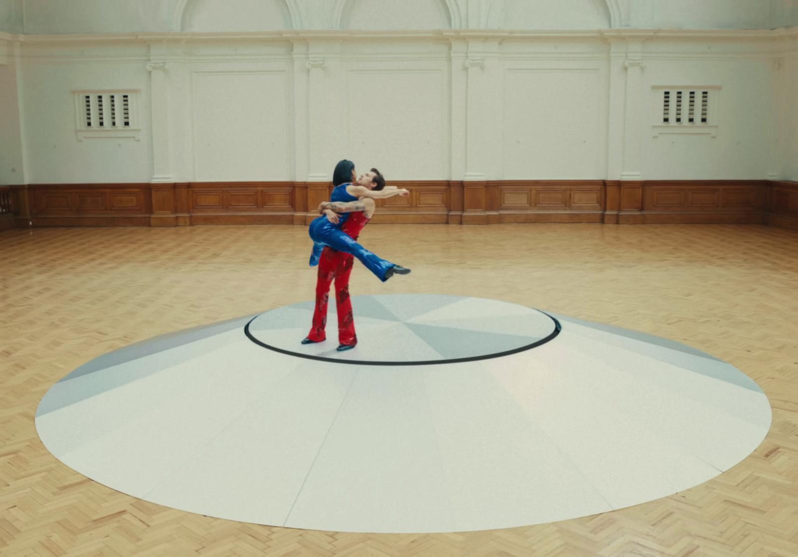 a couple of people that are standing on a floor