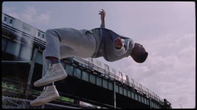 a man flying through the air while riding a skateboard