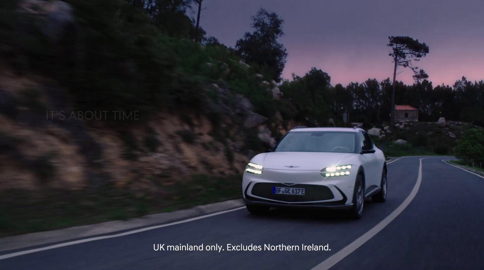 a white car driving down a curvy road