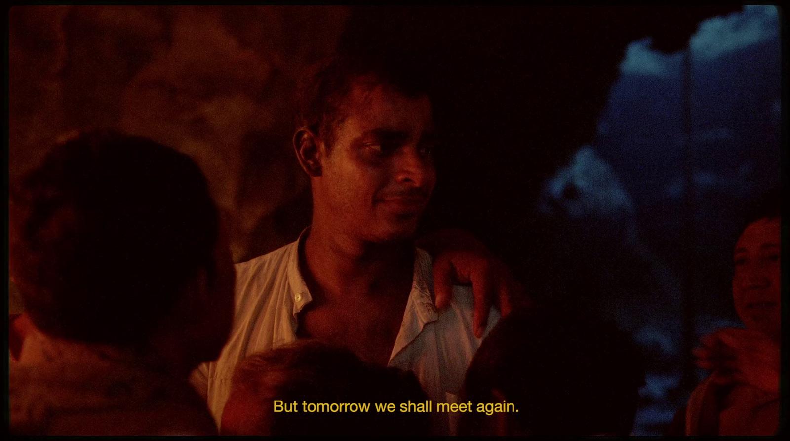 a man holding a child in a dark room