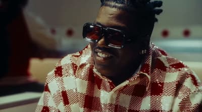 a man wearing sunglasses and a checkered shirt