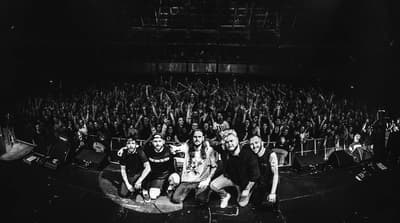 a group of people sitting on top of a stage
