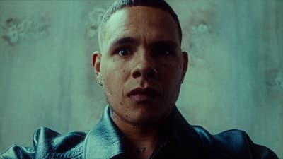 a close up of a person wearing a leather jacket
