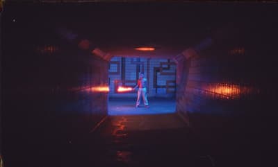 a person standing in a tunnel with a flashlight