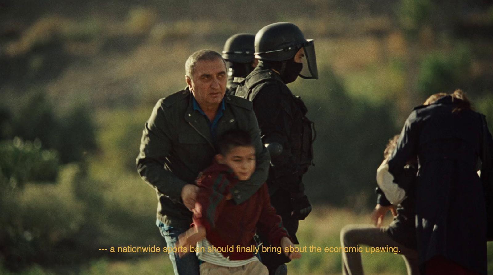 a man holding a young boy in front of a group of people