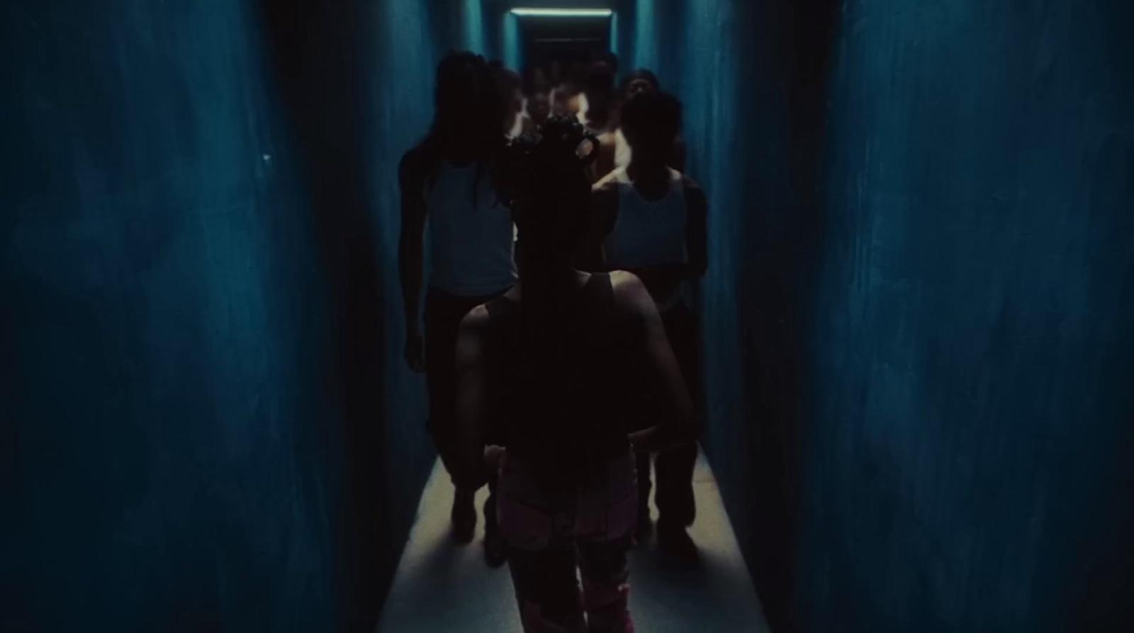 a group of people walking down a long hallway
