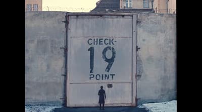 a man standing in front of a large sign