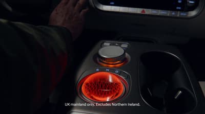 a car dashboard with a red light on it