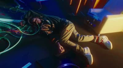 a man laying on the ground with a bunch of wires