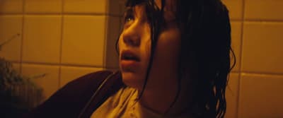 a woman with wet hair standing in a bathroom