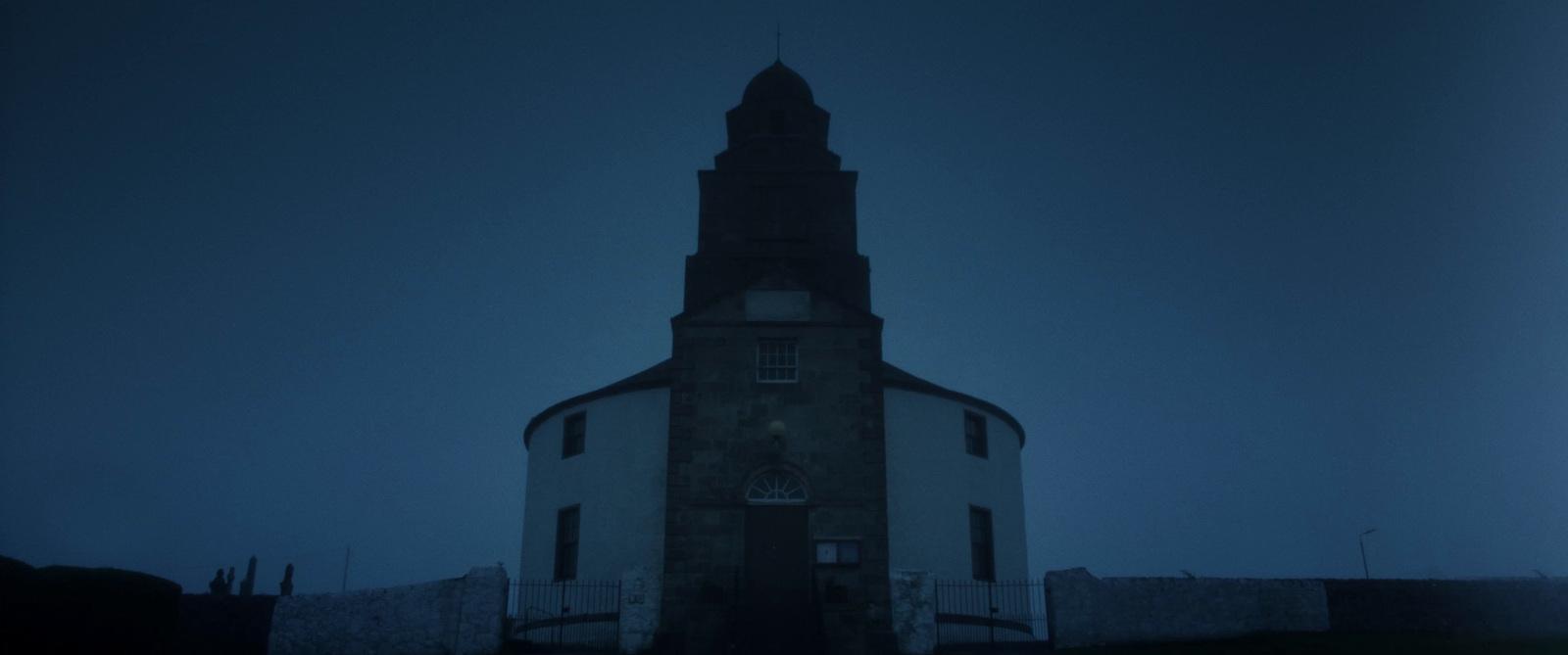 a tall tower with a clock on the top of it
