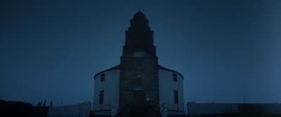 a tall tower with a clock on the top of it