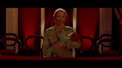 a woman holding a baby in her arms