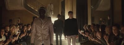 a group of men walking down a runway