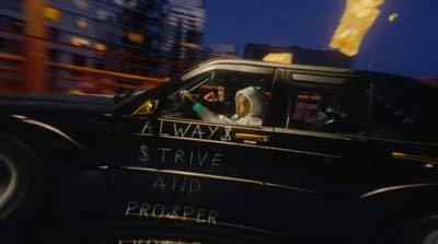 a car driving down a city street at night