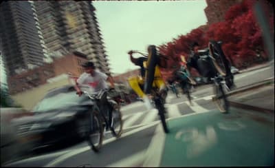 a group of people riding bikes down a street