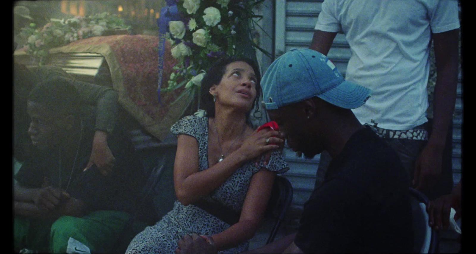 a woman sitting next to a man on a bench