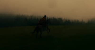 a blurry photo of a person riding a horse