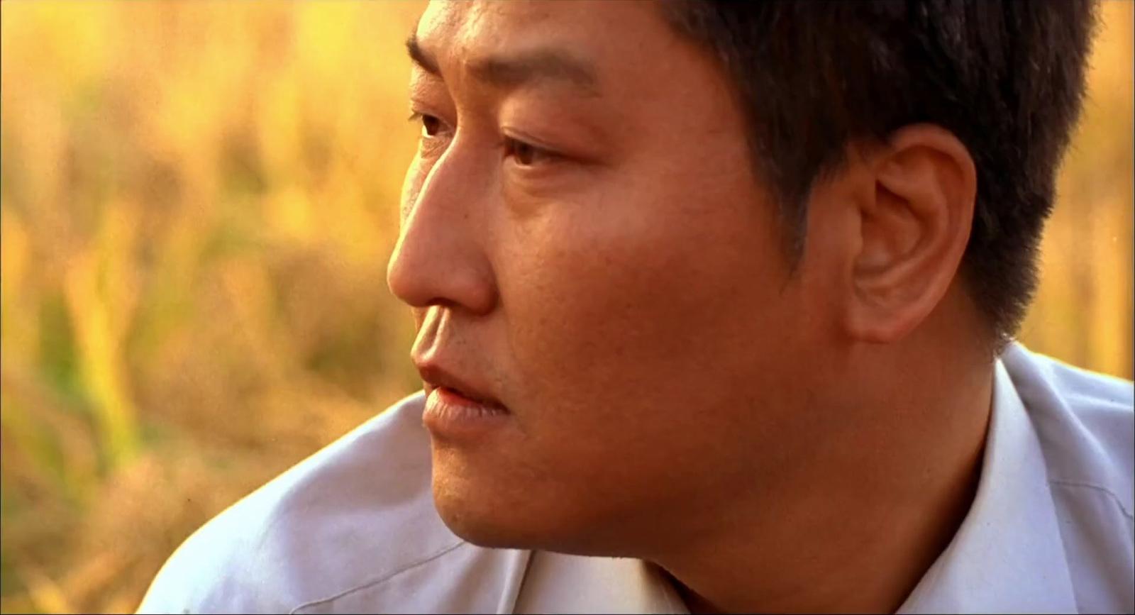 a close up of a person wearing a shirt and tie